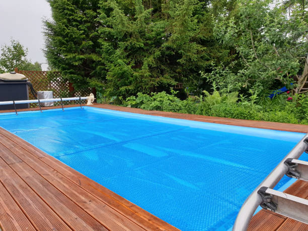 Swimming pool with cover being installed by professionals